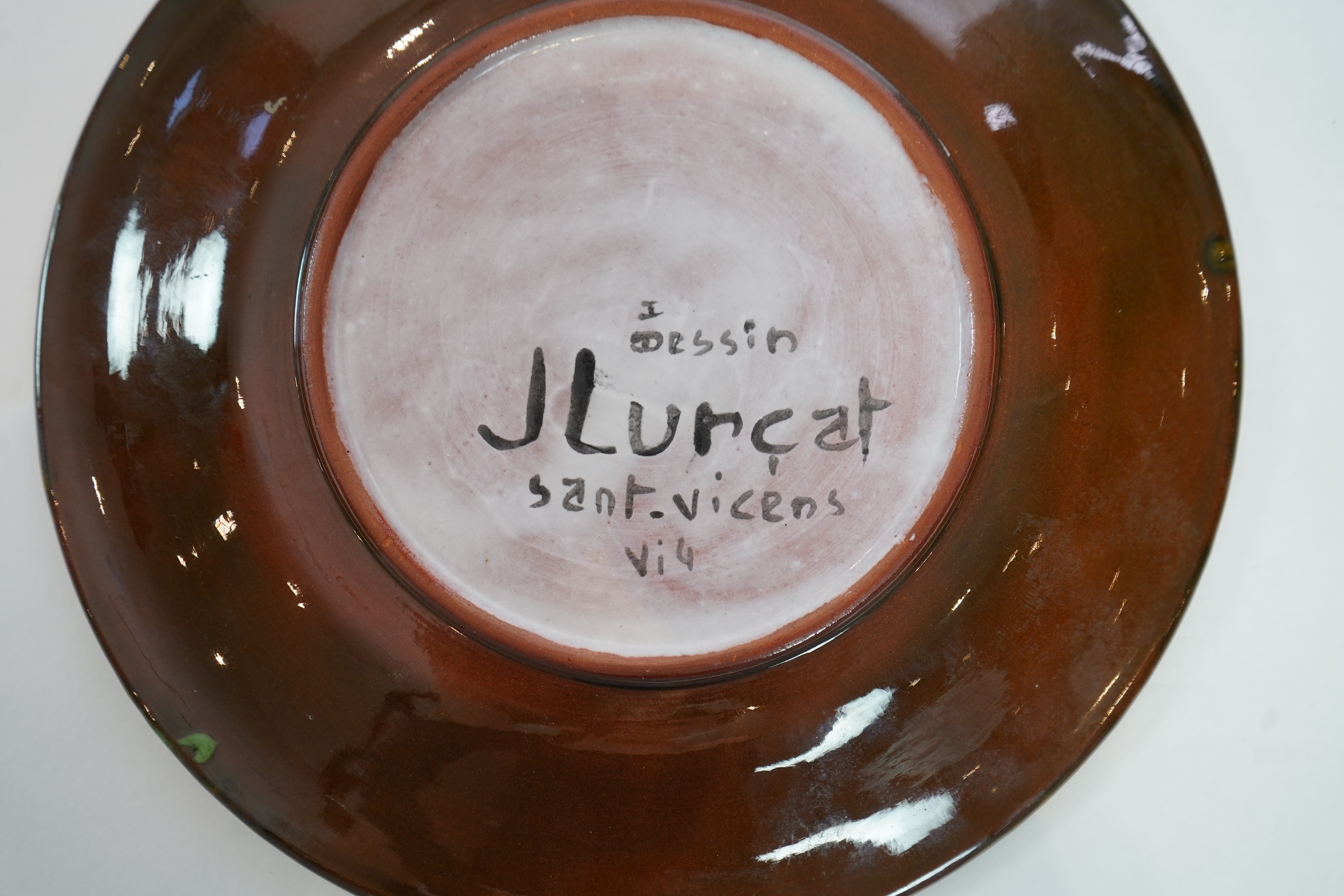 Jean Lurçat (1892-1966): A green glazed earthenware plate, decorated with a stylised central figure